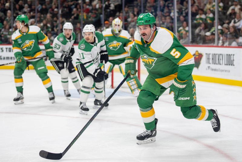 Nov 16, 2024; Saint Paul, Minnesota, USA; Minnesota Wild defenseman Jake Middleton (5) chases a loose puck against the Dallas Stars in the third period at Xcel Energy Center. Mandatory Credit: Matt Blewett-Imagn Images