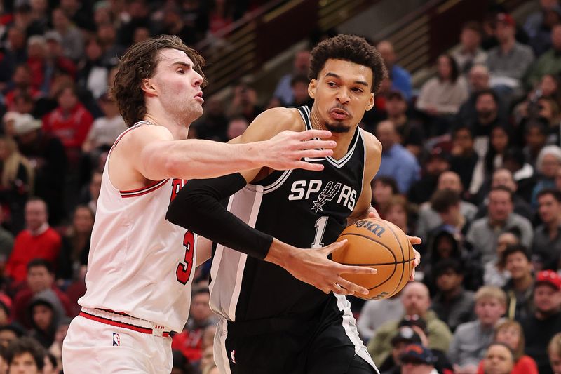 CHICAGO, ILLINOIS - JANUARY 06: Victor Wembanyama #1 of the San Antonio Spurs drives to the basket against Josh Giddey #3 of the Chicago Bulls during the second half at the United Center on January 06, 2025 in Chicago, Illinois. NOTE TO USER: User expressly acknowledges and agrees that, by downloading and or using this photograph, User is consenting to the terms and conditions of the Getty Images License Agreement.  (Photo by Michael Reaves/Getty Images)