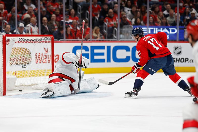 Jan 5, 2024; Washington, District of Columbia, USA; Washington Capitals center Dylan Strome (17) scores a goal on Carolina Hurricanes goaltender Pyotr Kochetkov (52) in the first period at Capital One Arena. Mandatory Credit: Geoff Burke-USA TODAY Sports