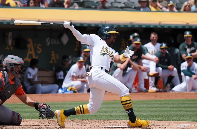 Jul 23, 2023; Oakland, California, USA; Oakland Athletics left fielder Tony Kemp (5) hits a single against the Houston Astros during the third inning at Oakland-Alameda County Coliseum. Mandatory Credit: Kelley L Cox-USA TODAY Sports