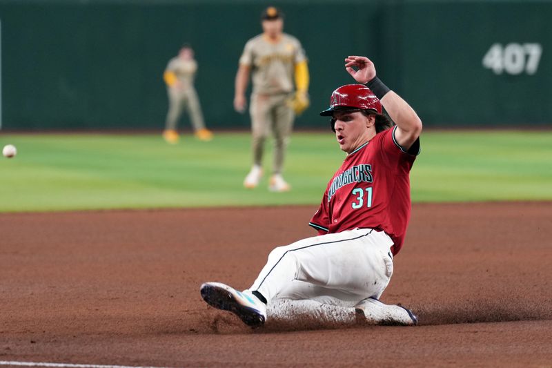 May 5, 2024; Phoenix, Arizona, USA; Arizona Diamondbacks outfielder Jake McCarthy (31) beats a throw to third base against the San Diego Padres during the fourth inning at Chase Field. Mandatory Credit: Joe Camporeale-USA TODAY Sports