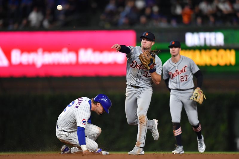 Aug 21, 2024; Chicago, Illinois, USA; Detroit Tigers second base Colt Keith (33) attempts a double play after forcing out Chicago Cubs second base Nico Hoerner (2) during the fifth inning at Wrigley Field. Mandatory Credit: Patrick Gorski-USA TODAY Sports