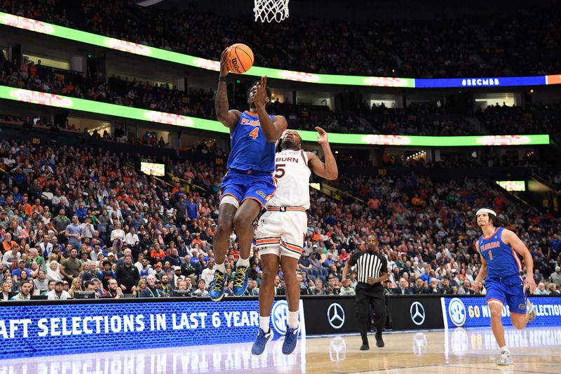 Mar 17, 2024; Nashville, TN, USA; Florida Gators forward Tyrese Samuel (4) shoots against Auburn Tigers forward Chris Moore (5) in the first half in the SEC Tournament championship game at Bridgestone Arena. Mandatory Credit: Steve Roberts-USA TODAY Sports