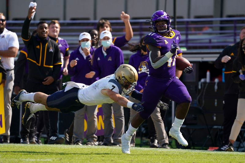 Oct 17, 2020; Greenville, North Carolina, USA;  East Carolina Pirates running back Rahjai Harris (47) scores a second half touchdown run against Navy Midshipmen defensive back Kevin Brennan (7) at Dowdy-Ficklen Stadium. Mandatory Credit: James Guillory-USA TODAY Sports