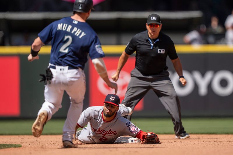 Jun 28, 2023; Seattle, Washington, USA; Washington Nationals Luis Garcia (2) falls to the ground after forcing out Seattle Mariners catcher Tom Murphy (2) at second base during the seventh inning at T-Mobile Park. Mandatory Credit: Stephen Brashear-USA TODAY Sports