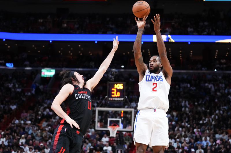 MIAMI, FLORIDA - FEBRUARY 04: Kawhi Leonard #2 of the LA Clippers goes up for a shot against Jaime Jaquez Jr. #11 of the Miami Heat during the third quarter at Kaseya Center on February 04, 2024 in Miami, Florida. User expressly acknowledges and agrees that, by downloading and or using this photograph, User is consenting to the terms and conditions of the Getty Images License Agreement. (Photo by Rich Storry/Getty Images)