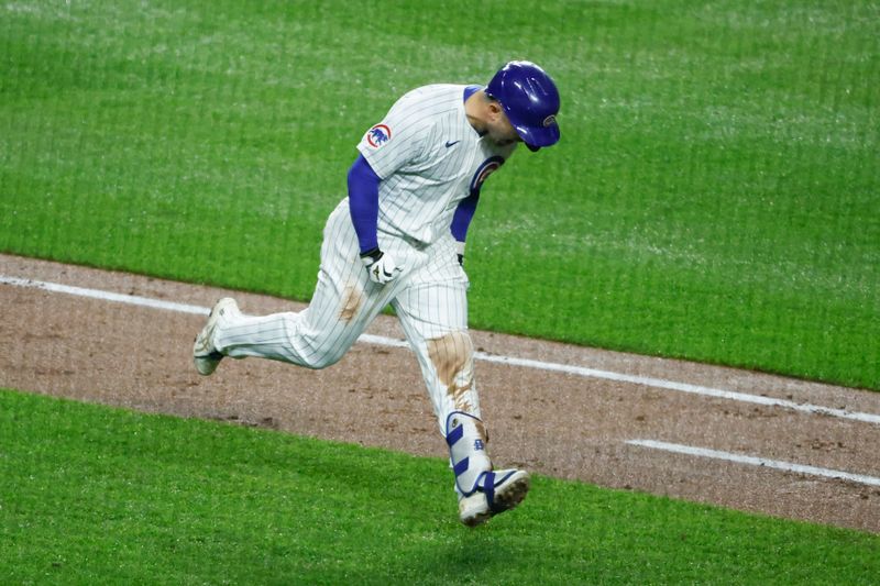 Jun 1, 2024; Chicago, Illinois, USA; Chicago Cubs outfielder Seiya Suzuki (27) rounds the bases after hitting a grand slam against the Cincinnati Reds during the second inning at Wrigley Field. Mandatory Credit: Kamil Krzaczynski-USA TODAY Sports