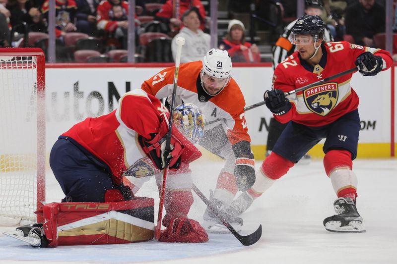 Feb 6, 2024; Sunrise, Florida, USA; Florida Panthers goaltender Anthony Stolarz (41) controls the puck after a shot by Philadelphia Flyers center Scott Laughton (21) during the first period at Amerant Bank Arena. Mandatory Credit: Sam Navarro-USA TODAY Sports