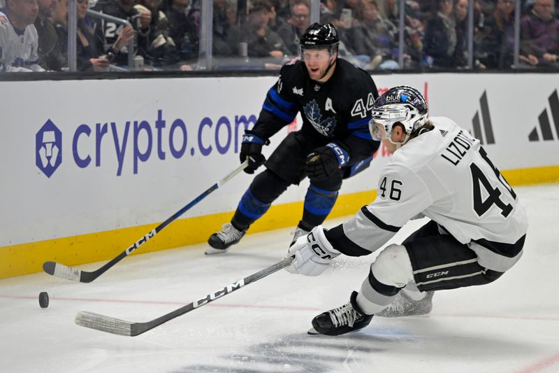 Jan 2, 2024; Los Angeles, California, USA; Los Angeles Kings center Blake Lizotte (46) and Toronto Maple Leafs defenseman Morgan Rielly (44) go for the puck in the second period at Crypto.com Arena. Mandatory Credit: Jayne Kamin-Oncea-USA TODAY Sports