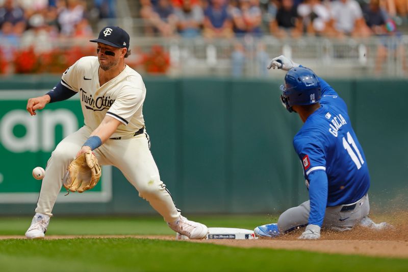 Aug 14, 2024; Minneapolis, Minnesota, USA; Kansas City Royals pinch runner Maikel Garcia (11) steals second base against Minnesota Twins second baseman Kyle Farmer (12) in the seventh inning at Target Field. Mandatory Credit: Bruce Kluckhohn-USA TODAY Sports