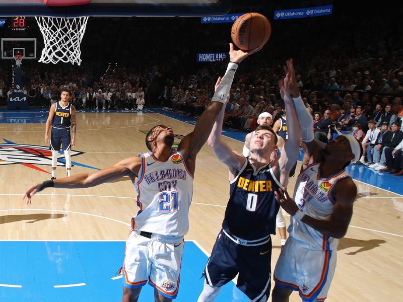 OKLAHOMA CITY, OK - MARCH 10: Aaron Wiggins #21 of the Oklahoma City Thunder rebounds during the game against the Denver Nuggets on March 10, 2025 at Paycom Center in Oklahoma City, Oklahoma. NOTE TO USER: User expressly acknowledges and agrees that, by downloading and or using this photograph, User is consenting to the terms and conditions of the Getty Images License Agreement. Mandatory Copyright Notice: Copyright 2025 NBAE(Photo by Zach Beeker/NBAE via Getty Images)
