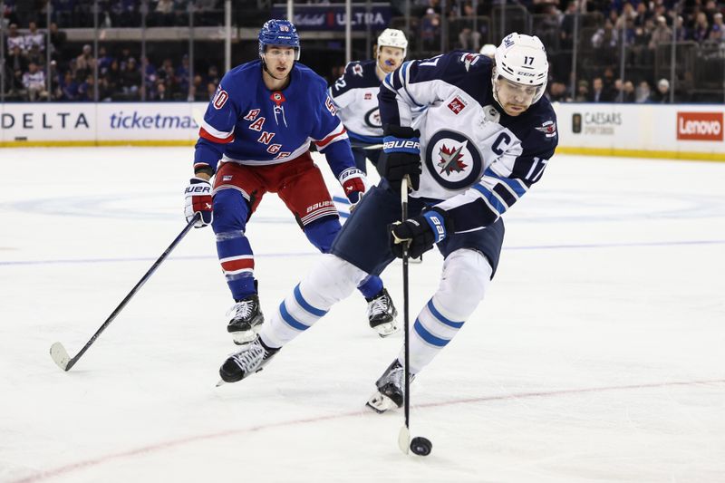 Nov 12, 2024; New York, New York, USA;  Winnipeg Jets center Adam Lowry (17) controls the puck in the third period against the New York Rangers at Madison Square Garden. Mandatory Credit: Wendell Cruz-Imagn Images