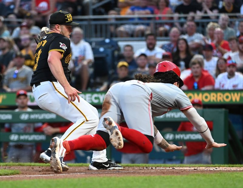 Aug 24, 2024; Pittsburgh, Pennsylvania, USA;  Cincinnati Reds second baseman Jonathan India (6) slides safety into home as Pittsburgh Pirates pitcher Hunter Stratton (63)  tries to apply the tag during the fourth inning at PNC Park. Stratton left the game with an apparent injury on the play. Mandatory Credit: Philip G. Pavely-USA TODAY Sports