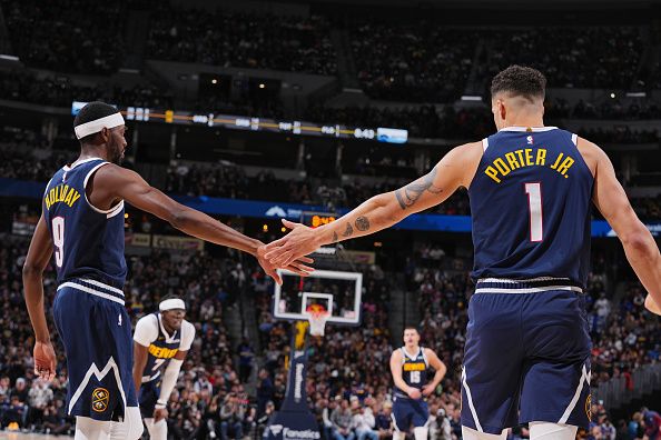 DENVER, CO - NOVEMBER 26: Justin Holiday #9 high fives Michael Porter Jr. #1 of the Denver Nuggets during the game against the San Antonio Spurs on November 26, 2023 at the Ball Arena in Denver, Colorado. NOTE TO USER: User expressly acknowledges and agrees that, by downloading and/or using this Photograph, user is consenting to the terms and conditions of the Getty Images License Agreement. Mandatory Copyright Notice: Copyright 2023 NBAE (Photo by Bart Young/NBAE via Getty Images)