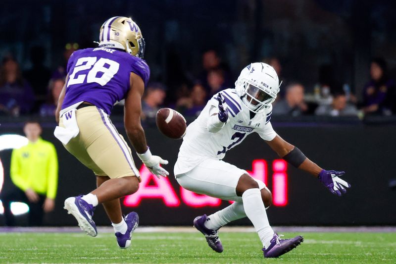 Sep 21, 2024; Seattle, Washington, USA; Washington Huskies linebacker Khmori House (28) intercepted a pass following a drop by Northwestern Wildcats wide receiver Calvin Johnson II (7) during the fourth quarter at Alaska Airlines Field at Husky Stadium. Mandatory Credit: Joe Nicholson-Imagn Images