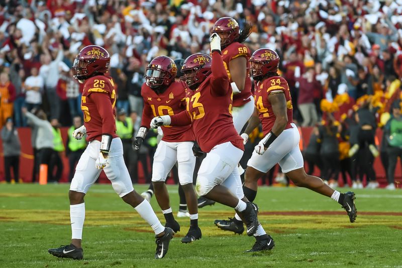 Oct 23, 2021; Ames, Iowa, USA;  Iowa State Cyclones defensive tackle Isaiah Lee (93) celebrates with linebacker O'Rien Vance (34) and defensive back T.J. Tampa (25) a fourth down stop against the Oklahoma State Cowboys in the second half at Jack Trice Stadium. Mandatory Credit: Steven Branscombe-USA TODAY Sports