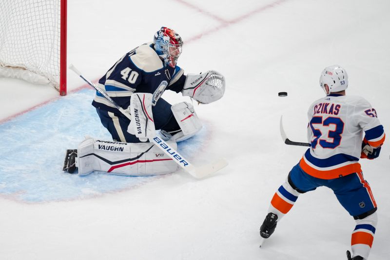 Apr 4, 2024; Columbus, Ohio, USA;  Columbus Blue Jackets goaltender Daniil Tarasov (40) makes a save in net against New York Islanders center Casey Cizikas (53) in the first period at Nationwide Arena. Mandatory Credit: Aaron Doster-USA TODAY Sports