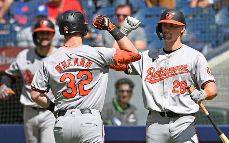 Jun 6, 2024; Toronto, Ontario, CAN;   Baltimore Orioles pinch hitter Ryan O'Hearn (32) is greeted by pinch hitter Kyle Stowers (28) after hitting a two run home run against the Toronto Blue Jays in the ninth inning at Rogers Centre. Mandatory Credit: Dan Hamilton-USA TODAY Sports