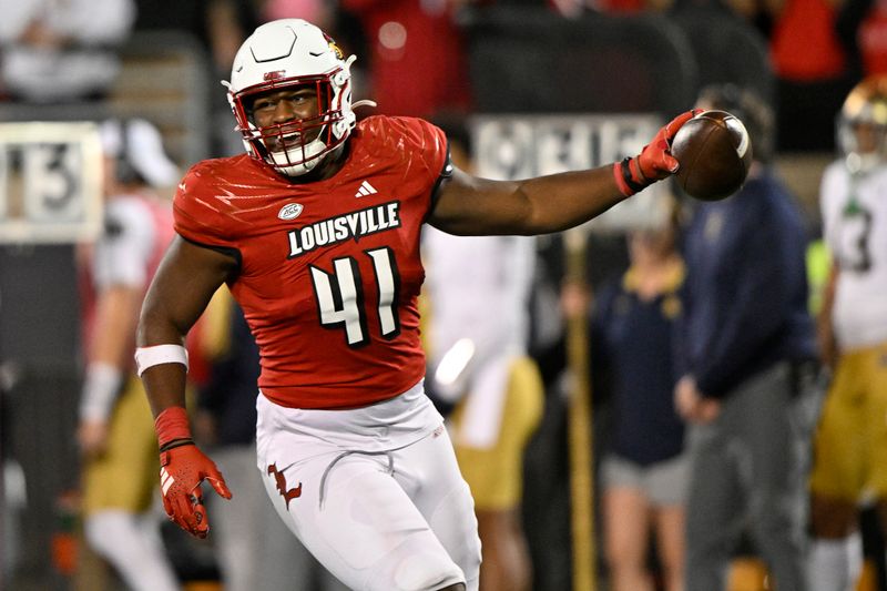 Oct 7, 2023; Louisville, Kentucky, USA;  Louisville Cardinals defensive lineman Ramon Puryear (41) celebrates after a defensive stop against the Notre Dame Fighting Irish during the second half at L&N Federal Credit Union Stadium. Louisville defeated Notre Dame 33-20. Mandatory Credit: Jamie Rhodes-USA TODAY Sports