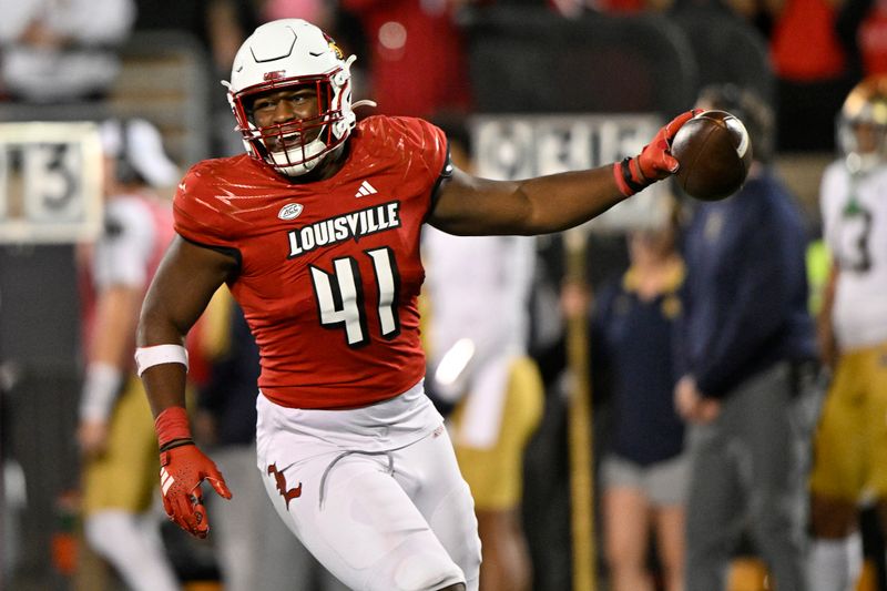 Oct 7, 2023; Louisville, Kentucky, USA;  Louisville Cardinals defensive lineman Ramon Puryear (41) celebrates after a defensive stop against the Notre Dame Fighting Irish during the second half at L&N Federal Credit Union Stadium. Louisville defeated Notre Dame 33-20. Mandatory Credit: Jamie Rhodes-USA TODAY Sports