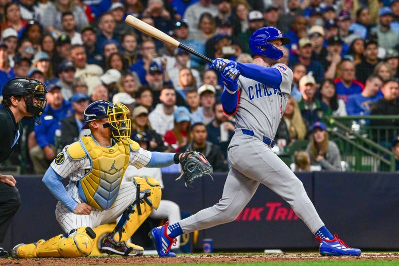 May 3, 2025; Milwaukee, Wisconsin, USA; Chicago Cubs center fielder Pete Crow-Armstrong (4) hits a 3-run home run as Milwaukee Brewers catcher William Contreras (24) looks on in the fourth inning at American Family Field. Mandatory Credit: Benny Sieu-Imagn Images