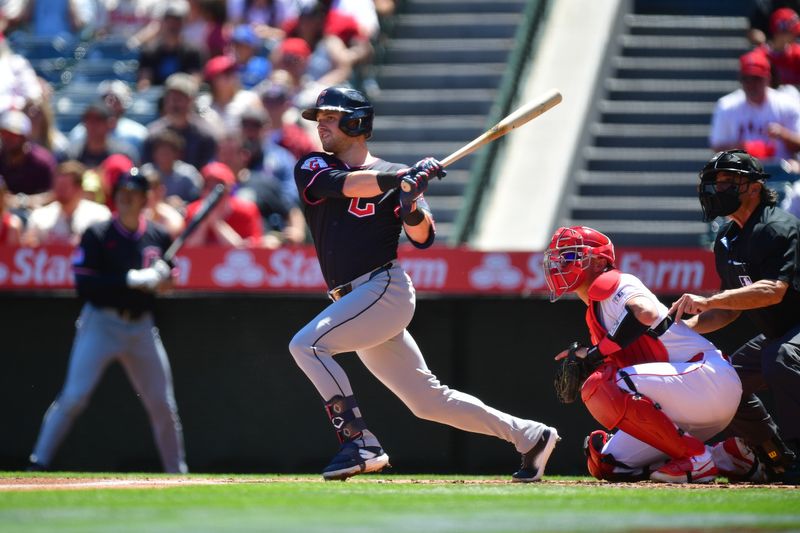 Apr 6, 2025; Anaheim, California, USA; Cleveland Guardians center fielder Lane Thomas (8) hits a sacrifice RBI against the Los Angeles Angels during the first inning at Angel Stadium. Mandatory Credit: Gary A. Vasquez-Imagn Images