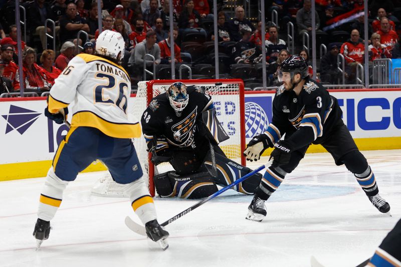 Nov 6, 2024; Washington, District of Columbia, USA; Washington Capitals goaltender Logan Thompson (48) makes a save on Nashville Predators center Philip Tomasino (26) in the second period at Capital One Arena. Mandatory Credit: Geoff Burke-Imagn Images