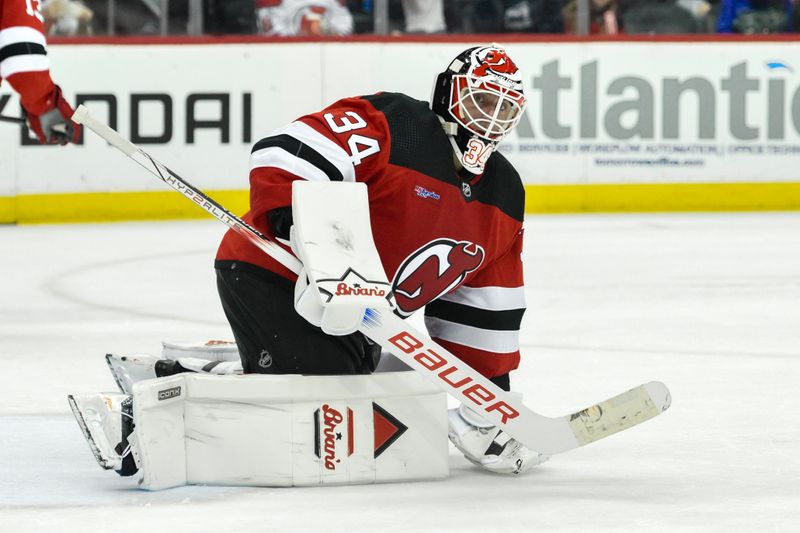 Apr 2, 2024; Newark, New Jersey, USA; New Jersey Devils goaltender Jake Allen (34) tends net during the third period against the Pittsburgh Penguins at Prudential Center. Mandatory Credit: John Jones-USA TODAY Sports