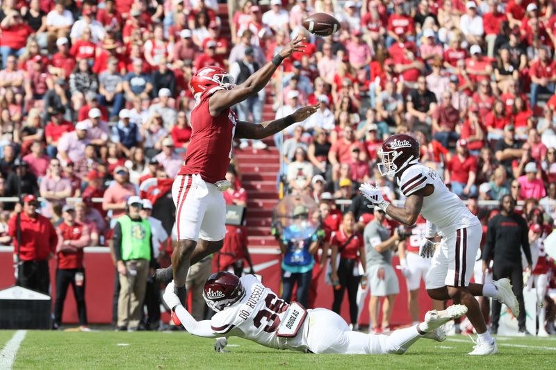 Oct 21, 2023; Fayetteville, Arkansas, USA;  Arkansas Razorbacks quarterback KJ Jefferson (1) throws a pass against Mississippi State Bulldogs defensive lineman Monterey Russell (36) at Donald W. Reynolds Razorback Stadium. Mandatory Credit: Nelson Chenault-USA TODAY Sports