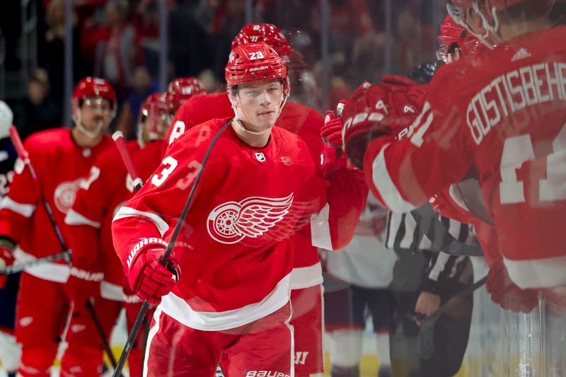 Nov 11, 2023; Detroit, Michigan, USA;  Detroit Red Wings left wing Lucas Raymond (23) celebrates with teammates after scoring against the Columbus Blue Jackets in the first period at Little Caesars Arena. Mandatory Credit: Rick Osentoski-USA TODAY Sports