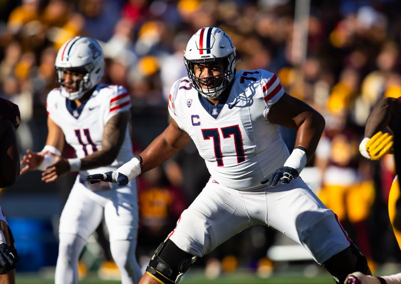 Nov 25, 2023; Tempe, Arizona, USA; Arizona Wildcats offensive lineman Jordan Morgan (77) against the Arizona State Sun Devils during the Territorial Cup at Mountain America Stadium. Mandatory Credit: Mark J. Rebilas-USA TODAY Sports