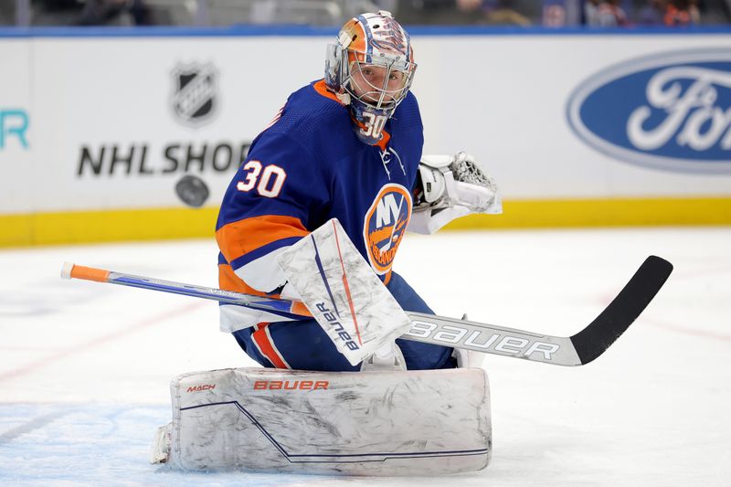 Jan 21, 2024; Elmont, New York, USA; New York Islanders goaltender Ilya Sorokin (30) plays the puck against the Dallas Stars during the first period at UBS Arena. Mandatory Credit: Brad Penner-USA TODAY Sports