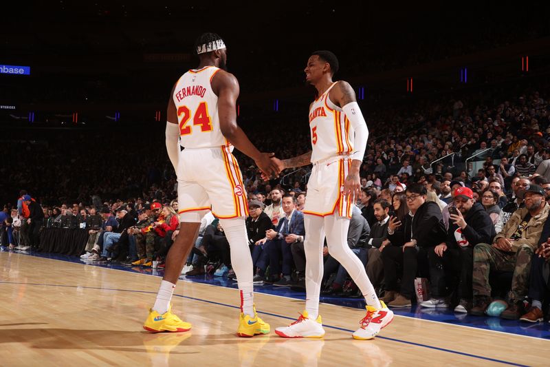 NEW YORK, NY - MARCH 5: Bruno Fernando #24 high fives  Dejounte Murray #5 of the Atlanta Hawks during the game against the New York Knicks on March 5, 2024 at Madison Square Garden in New York City, New York.  NOTE TO USER: User expressly acknowledges and agrees that, by downloading and or using this photograph, User is consenting to the terms and conditions of the Getty Images License Agreement. Mandatory Copyright Notice: Copyright 2024 NBAE  (Photo by Nathaniel S. Butler/NBAE via Getty Images)