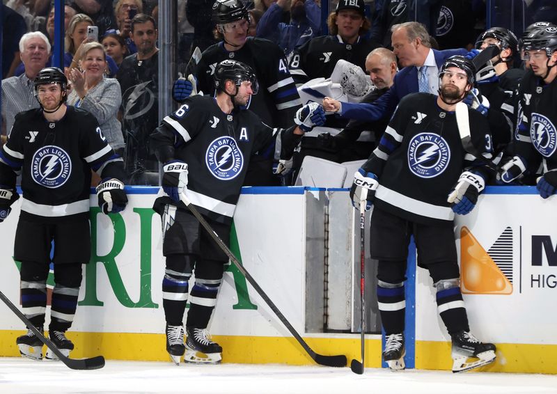Oct 25, 2025; Tampa, Florida, USA; Tampa Bay Lightning right wing Nikita Kucherov (86) is congratulated by head coach Jon Cooper after he got an assist and his 1,000 career point against the Anaheim Ducks during the second period at Benchmark International Arena. Mandatory Credit: Kim Klement Neitzel-Imagn Images