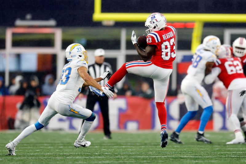 New England Patriots wide receiver Jalen Reagor (83) plays against Los Angeles Chargers cornerback Deane Leonard (33) during the second half of an NFL football game, Sunday, Dec. 3, 2023, in Foxborough, Mass. (AP Photo/Michael Dwyer)