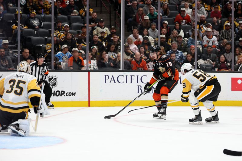 Nov 7, 2023; Anaheim, California, USA; Anaheim Ducks right wing Troy Terry (19) shoots the puck against Pittsburgh Penguins goaltender Tristan Jarry (35) during the second period at Honda Center. Mandatory Credit: Kiyoshi Mio-USA TODAY Sports