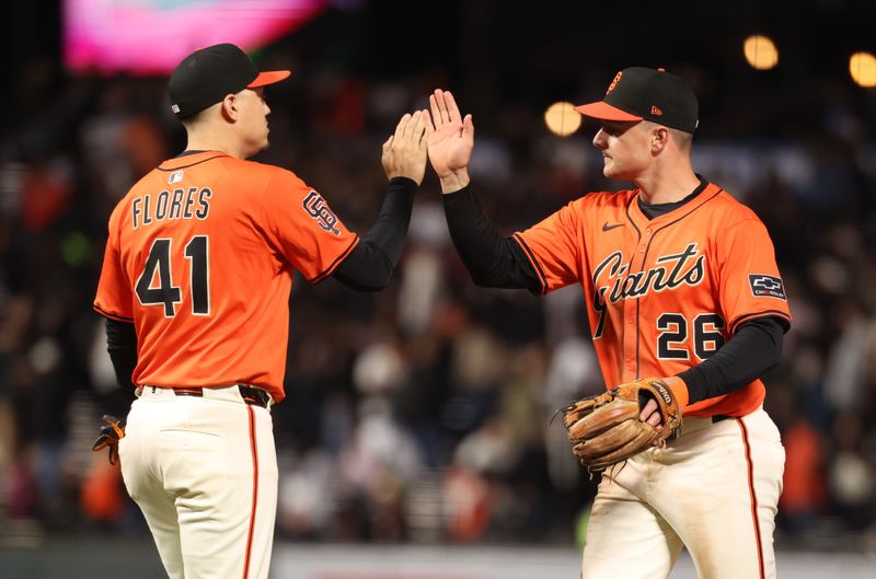 May 2, 2025; San Francisco, California, USA; San Francisco Giants designated hitter Wilmer Flores (41) and third baseman Matt Chapman (26) high five after the game against the Colorado Rockies at Oracle Park. Mandatory Credit: Kelley L Cox-Imagn Images