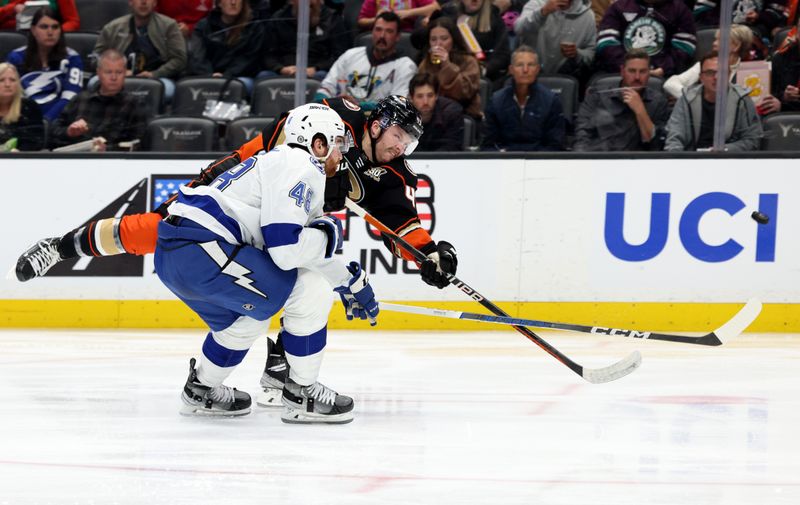 Mar 24, 2024; Anaheim, California, USA; Anaheim Ducks left wing Max Jones (49) shoots against Tampa Bay Lightning defenseman Nick Perbix (48) during the second period at Honda Center. Mandatory Credit: Jason Parkhurst-USA TODAY Sports