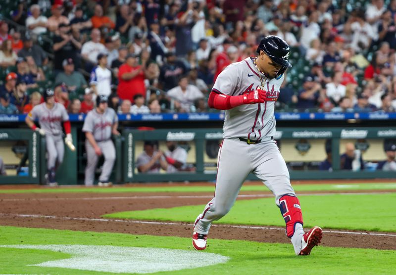 Apr 17, 2024; Houston, Texas, USA; Atlanta Braves shortstop Orlando Arcia (11) stops running around the and watches his RBI sacrifice against the Houston Astros in the eighth inning at Minute Maid Park. Mandatory Credit: Thomas Shea-USA TODAY Sports