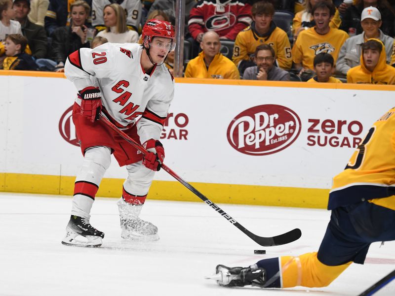 Dec 27, 2023; Nashville, Tennessee, USA; Carolina Hurricanes center Sebastian Aho (20) skates with the puck during the second period against the Nashville Predators at Bridgestone Arena. Mandatory Credit: Christopher Hanewinckel-USA TODAY Sports