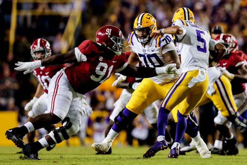 Nov 5, 2022; Baton Rouge, Louisiana, USA; Alabama Crimson Tide defensive lineman Jaheim Oatis (91) misses the tackle of LSU Tigers quarterback Jayden Daniels (5)  during the second half at Tiger Stadium. Mandatory Credit: Stephen Lew-USA TODAY Sports