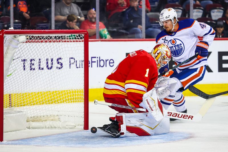Sep 21, 2025; Calgary, Alberta, CAN; Edmonton Oilers right wing Kasperi Kapanen (42) scores a goal against Calgary Flames goaltender Devin Cooley (1) during the first period at Scotiabank Saddledome. Mandatory Credit: Sergei Belski-Imagn Images