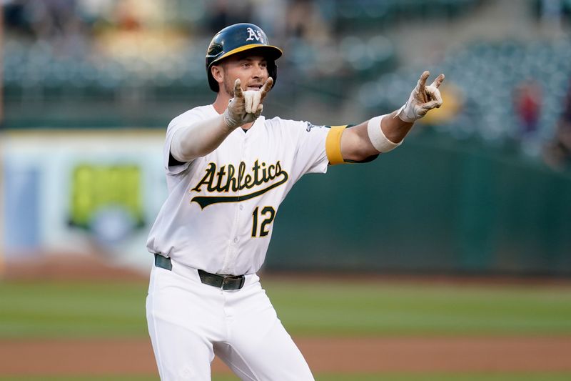 Jul 19, 2024; Oakland, California, USA; Oakland Athletics shortstop Max Schuemann (12) reacts after hitting a three-run home run against the Los Angeles Angels in the fourth inning at Oakland-Alameda County Coliseum. Mandatory Credit: Cary Edmondson-USA TODAY Sports