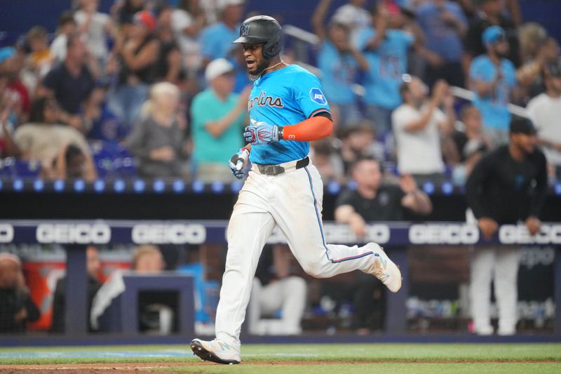 Aug 25, 2024; Miami, Florida, USA;  Miami Marlins second baseman Otto Lopez (61) scores a run in the eighth inning against the Chicago Cubs at loanDepot Park. Mandatory Credit: Jim Rassol-USA TODAY Sports