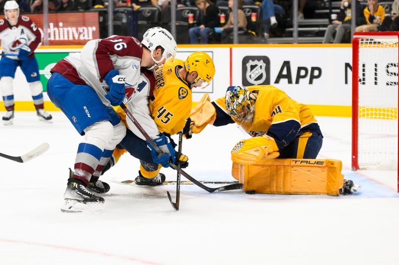 Nov 2, 2024; Nashville, Tennessee, USA;  Nashville Predators goaltender Juuse Saros (74) and defenseman Alexandre Carrier (45) blocks the shot of Colorado Avalanche right wing Mikko Rantanen (96) during the second period at Bridgestone Arena. Mandatory Credit: Steve Roberts-Imagn Images