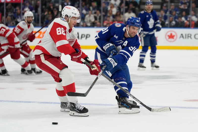 Nov 8, 2024; Toronto, Ontario, CAN; Toronto Maple Leafs forward John Tavares (91) scores an empty net goal as Detroit Red Wings forward Patrick Kane (88) tries to defend during the third period at Scotiabank Arena. Mandatory Credit: John E. Sokolowski-Imagn Images