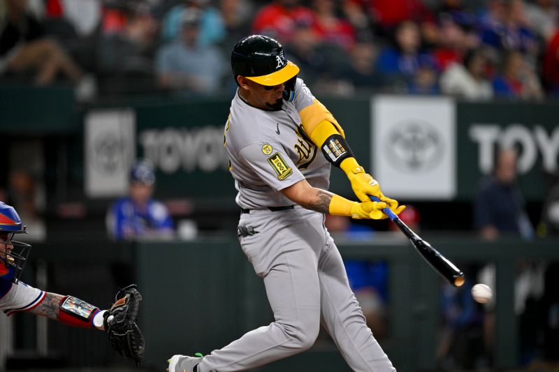 May 1, 2025; Arlington, Texas, USA; Athletics catcher Jhonny Pereda (64) bats against the Texas Rangers during the fifth inning at Globe Life Field. Mandatory Credit: Jerome Miron-Imagn Images