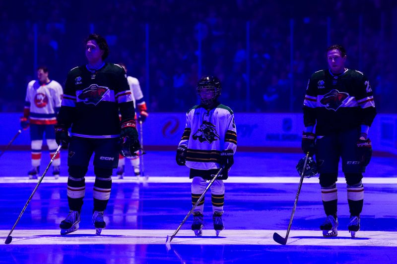 Jan 15, 2024; Saint Paul, Minnesota, USA; Minnesota Wild defenseman Brock Faber (7) and center Marco Rossi (23) look on prior to the game against the New York Islanders at Xcel Energy Center. Mandatory Credit: Brace Hemmelgarn-USA TODAY Sports