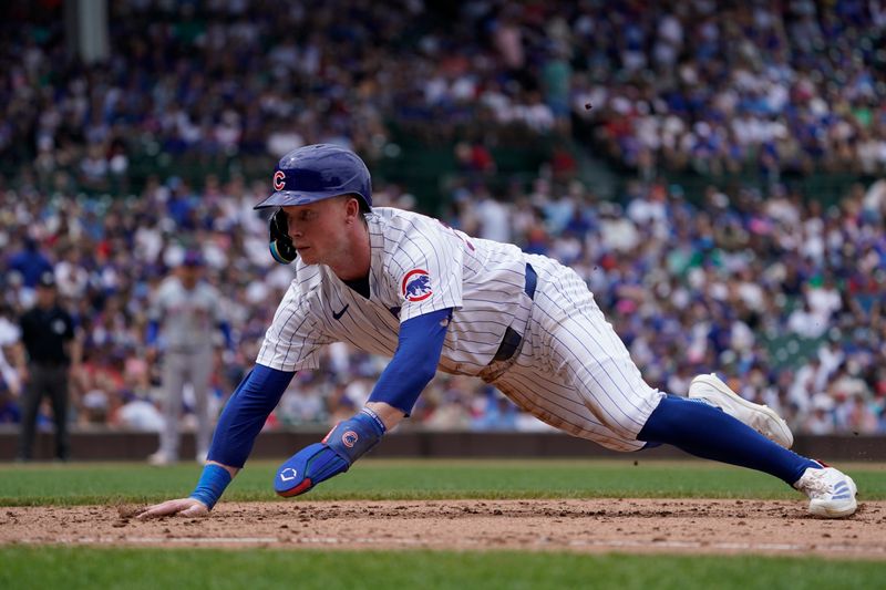 Jun 22, 2024; Chicago, Illinois, USA; Chicago Cubs outfielder Pete Crow-Armstrong (52) dives safely into first base against the New York Mets during the sixth inning at Wrigley Field. Mandatory Credit: David Banks-USA TODAY Sports