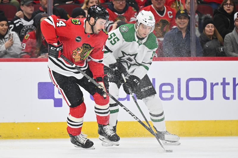 Jan 13, 2024; Chicago, Illinois, USA;  Chicago Blackhawks forward Boris Katchouk (14) and Dallas Stars defenseman Thomas Harley (55) battle for control of the puck in the first period at United Center. Mandatory Credit: Jamie Sabau-USA TODAY Sports